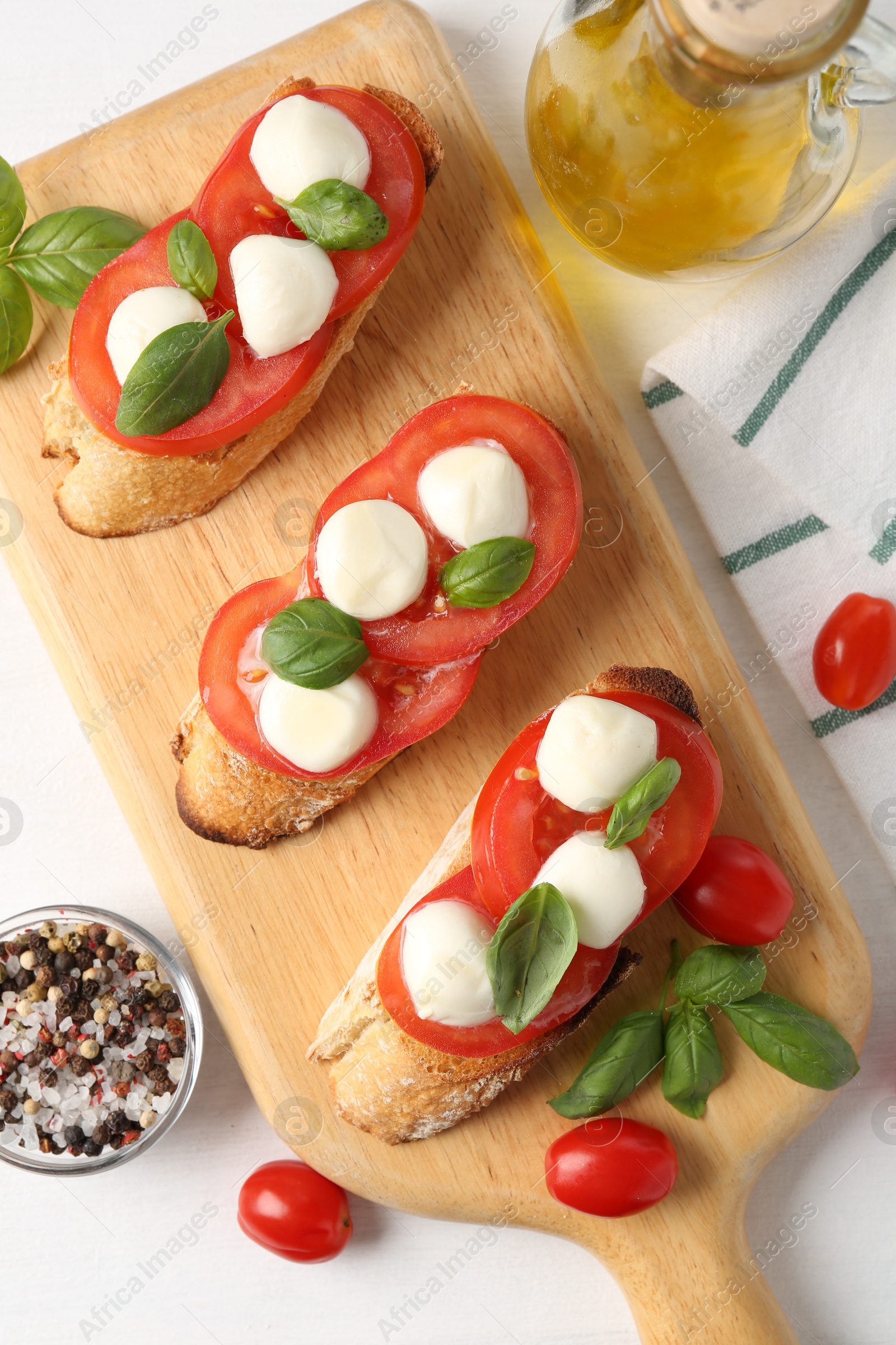 Tasty sandwiches with mozzarella cheese, tomatoes and basil on white table, flat lay Photo of Tasty sandwiches with mozzarella cheese, tomatoes and basil on white table, flat lay