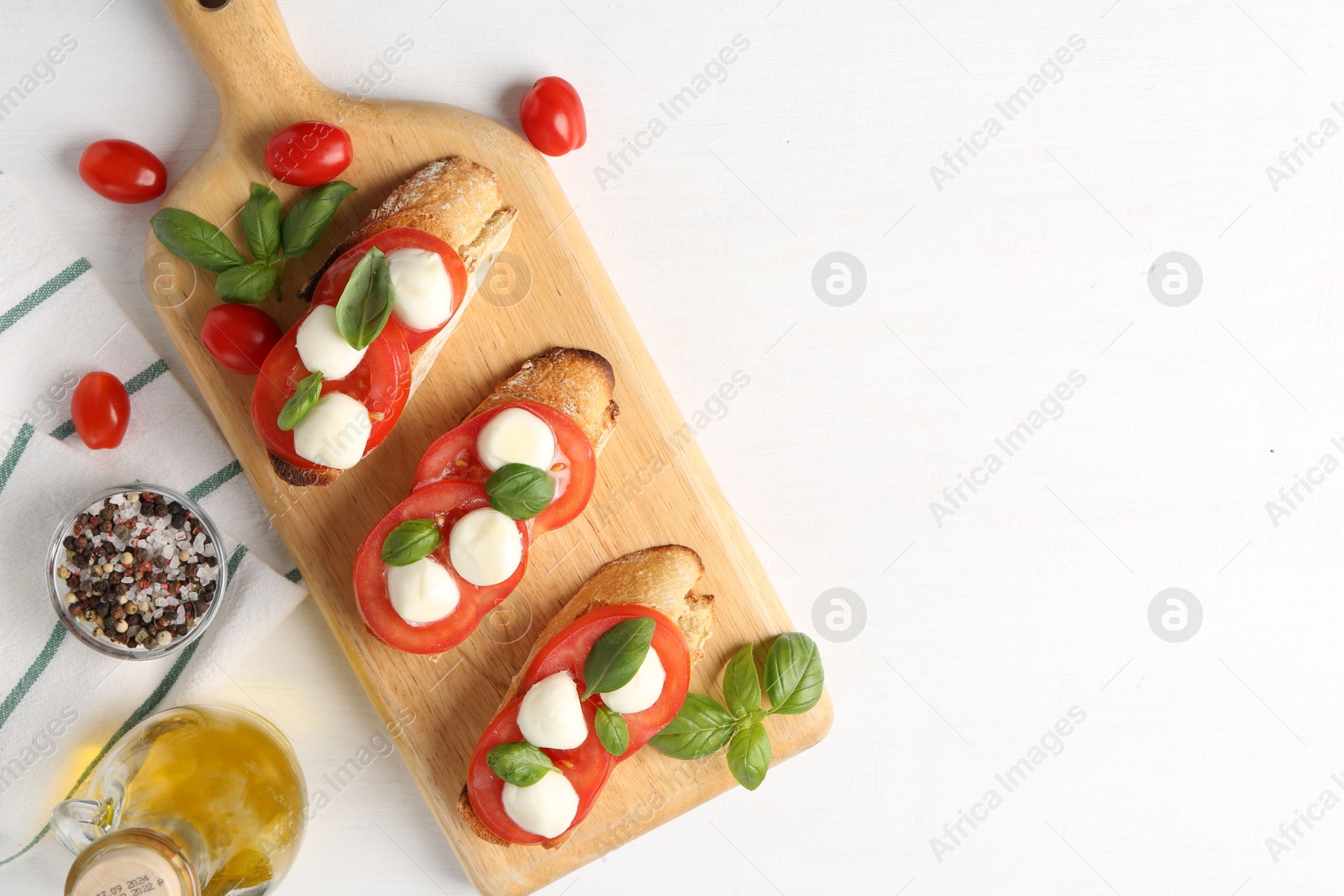 Tasty sandwiches with mozzarella cheese, tomatoes and basil on white table, flat lay. Space for text Photo of Tasty sandwiches with mozzarella cheese, tomatoes and basil on white table, flat lay. Space for text