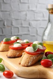 Photo of Tasty sandwiches with mozzarella cheese, tomatoes and basil on table, closeup