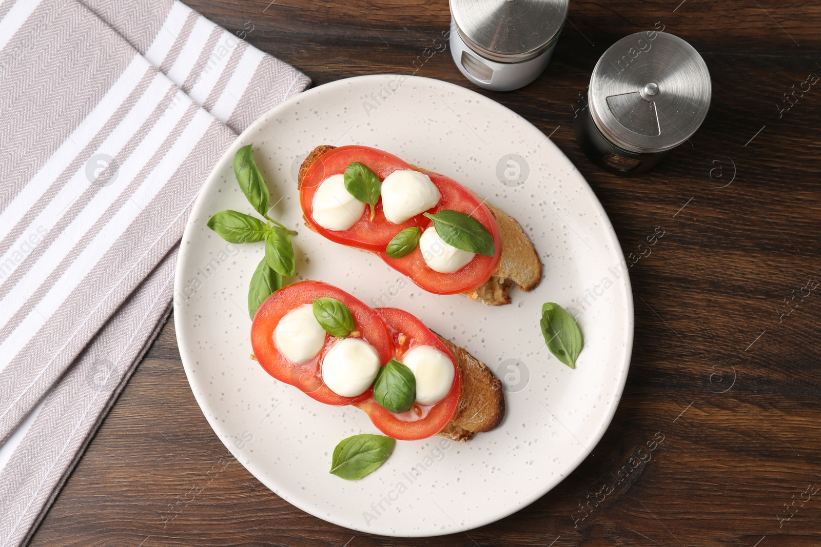 Tasty sandwiches with mozzarella cheese, tomatoes and basil on wooden table, flat lay Photo of Tasty sandwiches with mozzarella cheese, tomatoes and basil on wooden table, flat lay