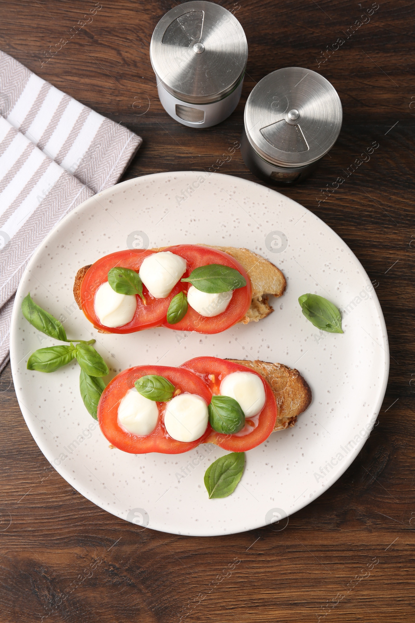 Tasty sandwiches with mozzarella cheese, tomatoes and basil on wooden table, flat lay Photo of Tasty sandwiches with mozzarella cheese, tomatoes and basil on wooden table, flat lay