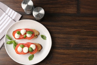 Photo of Tasty sandwiches with mozzarella cheese, tomatoes and basil on wooden table, flat lay. Space for text
