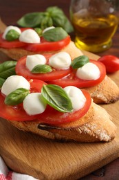 Photo of Tasty sandwiches with mozzarella cheese, tomatoes and basil on table, closeup