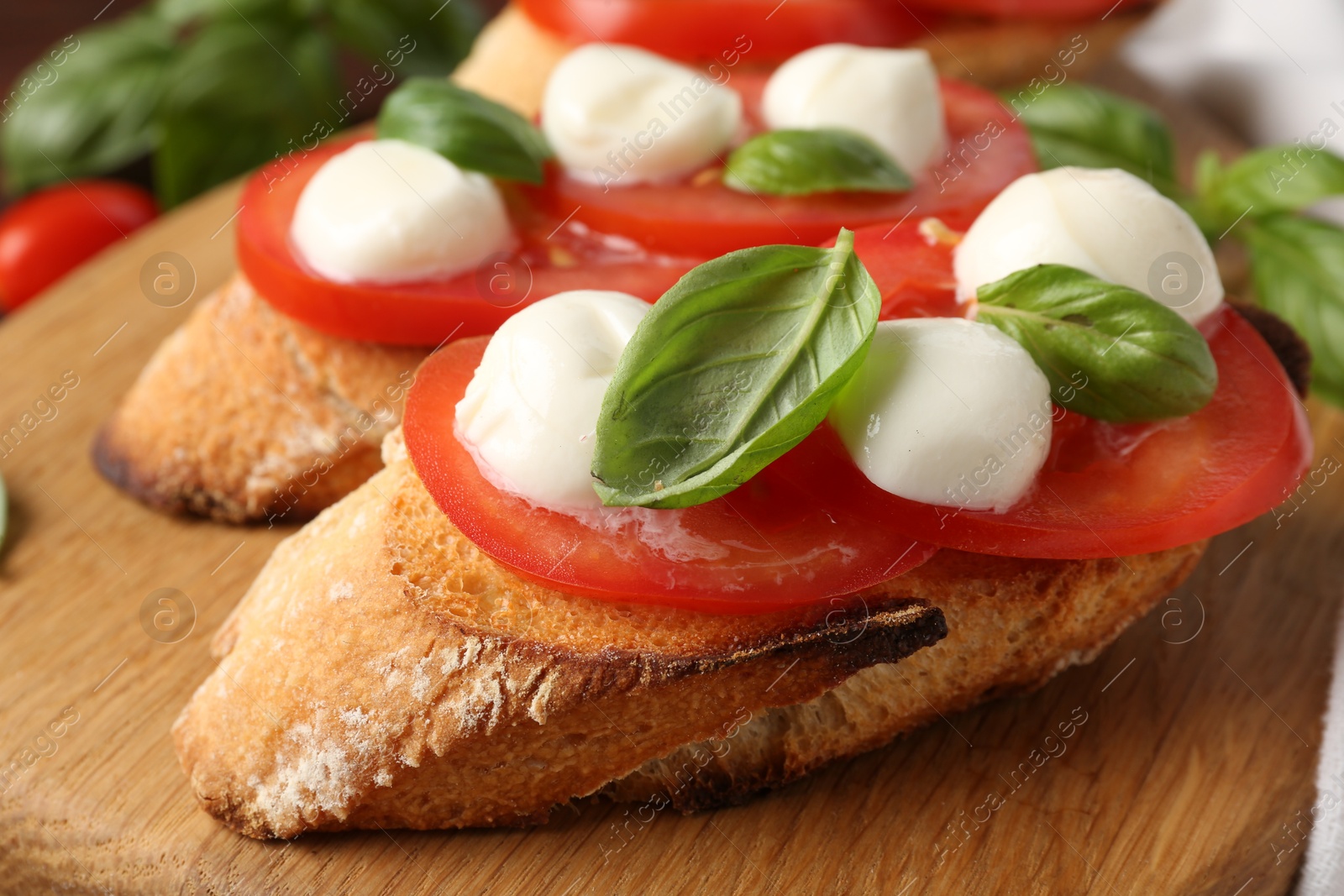 Tasty sandwiches with mozzarella cheese, tomatoes and basil on table, closeup Photo of Tasty sandwiches with mozzarella cheese, tomatoes and basil on table, closeup