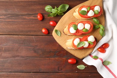 Photo of Tasty sandwiches with mozzarella cheese, tomatoes and basil on wooden table, flat lay. Space for text