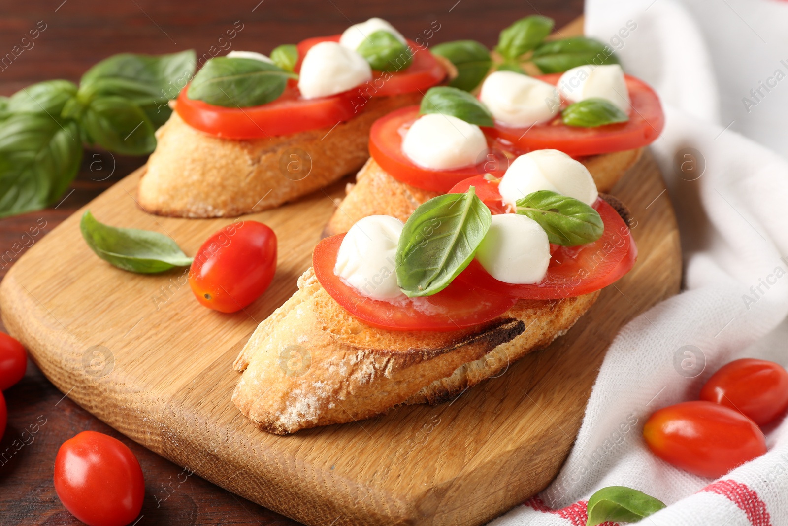 Photo of Tasty sandwiches with mozzarella cheese, tomatoes and basil on wooden table, closeup