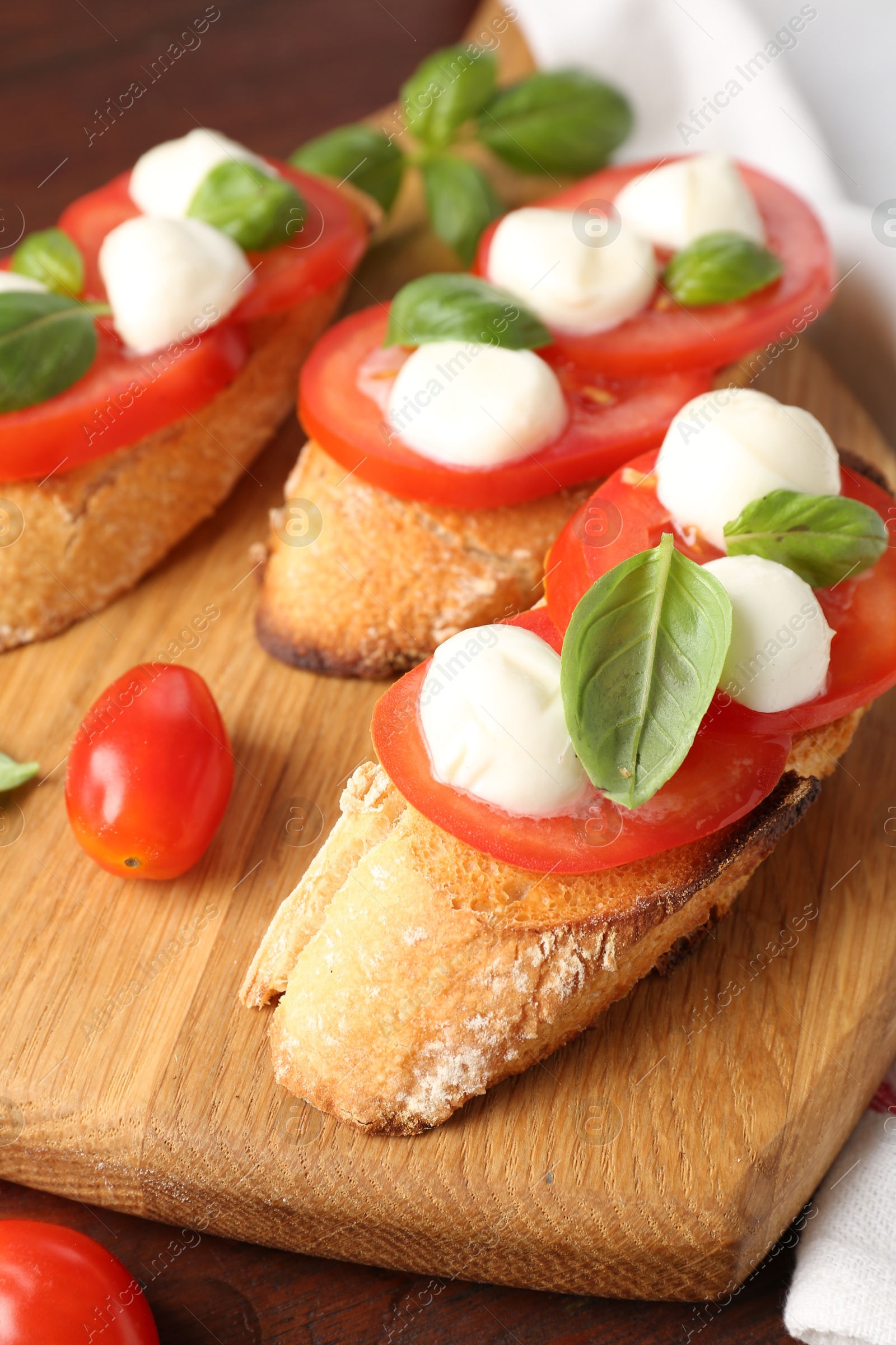 Photo of Tasty sandwiches with mozzarella cheese, tomatoes and basil on table, closeup