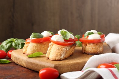 Photo of Tasty sandwiches with mozzarella cheese, tomatoes and basil on wooden table, closeup