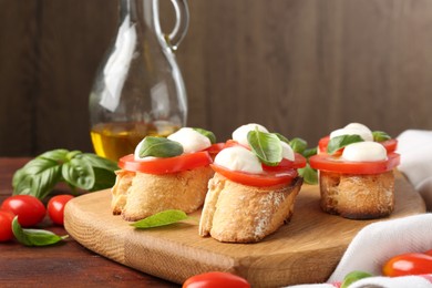 Photo of Tasty sandwiches with mozzarella cheese, tomatoes and basil on wooden table, closeup