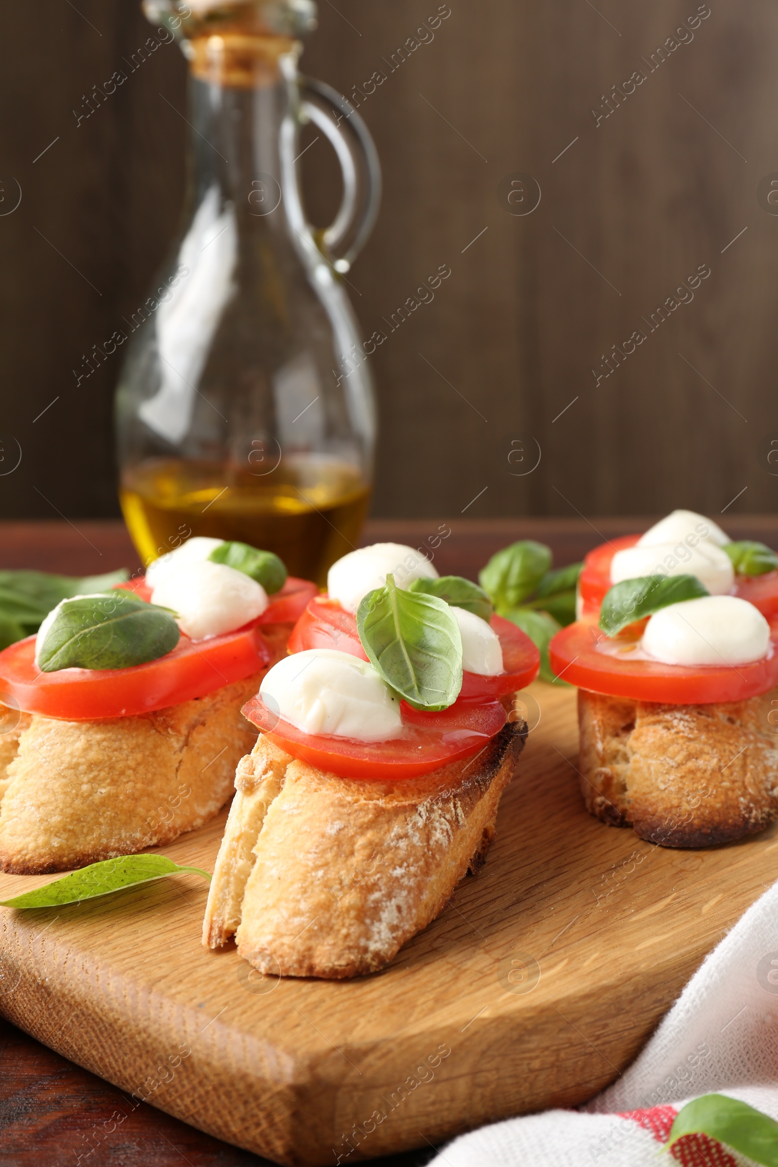 Photo of Tasty sandwiches with mozzarella cheese, tomatoes and basil on table, closeup