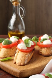 Photo of Tasty sandwiches with mozzarella cheese, tomatoes and basil on table, closeup