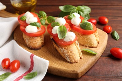 Photo of Tasty sandwiches with mozzarella cheese, tomatoes and basil on wooden table, closeup