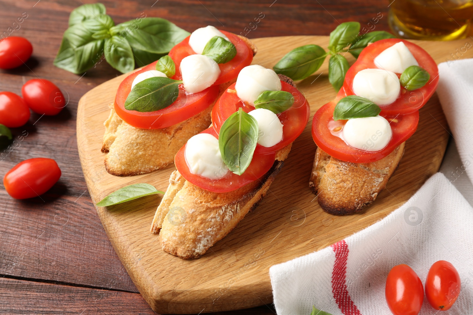 Photo of Tasty sandwiches with mozzarella cheese, tomatoes and basil on wooden table, closeup