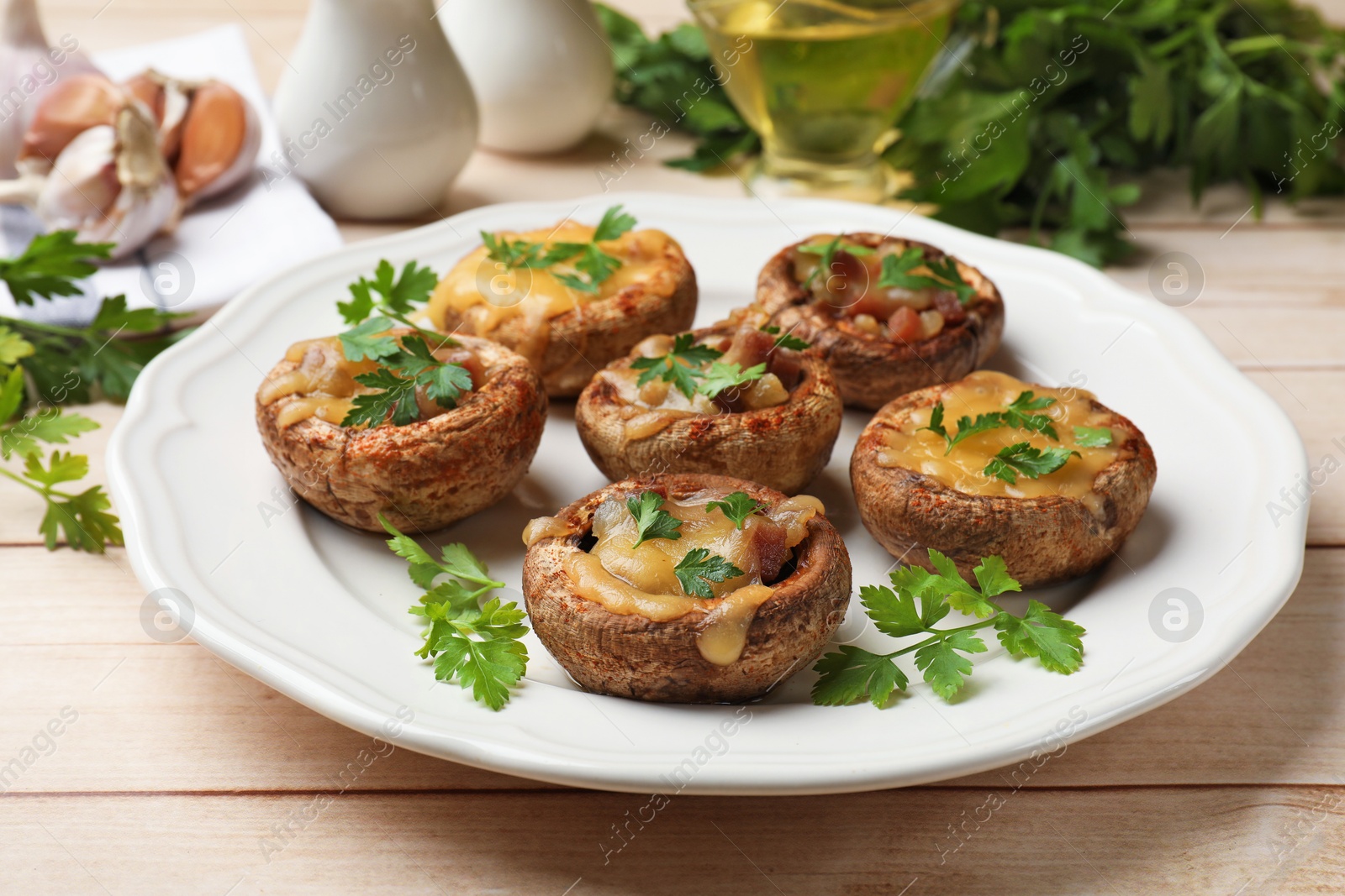 Tasty stuffed mushrooms served on wooden table, closeup Photo of Tasty stuffed mushrooms served on wooden table, closeup