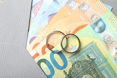 Photo of Silver wedding rings, envelope and euro banknotes, top view