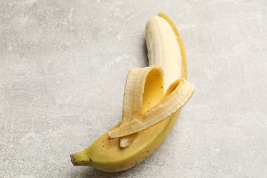 Photo of Banana with heart made of peel on grey table, above view