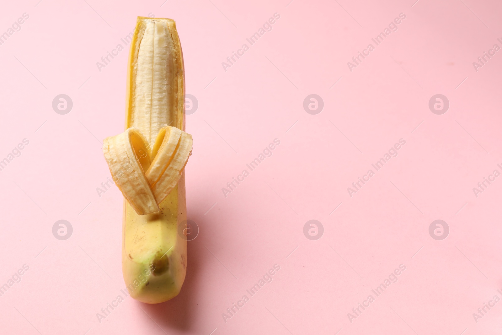 Banana with heart made of peel on pink background, closeup. Space for text Photo of Banana with heart made of peel on pink background, closeup. Space for text