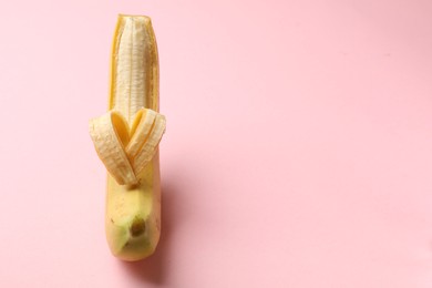 Photo of Banana with heart made of peel on pink background, closeup. Space for text