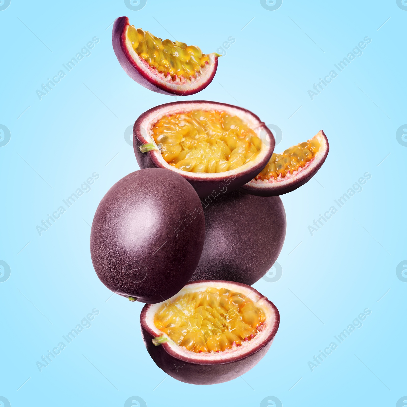 Delicious ripe passion fruits falling on light blue background Image of Delicious ripe passion fruits falling on light blue background