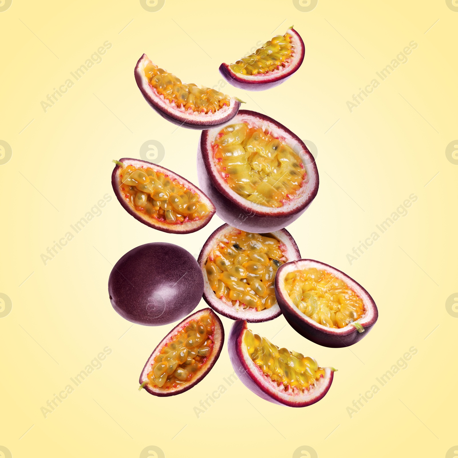 Delicious ripe passion fruits falling on pale yellow gradient background Image of Delicious ripe passion fruits falling on pale yellow gradient background