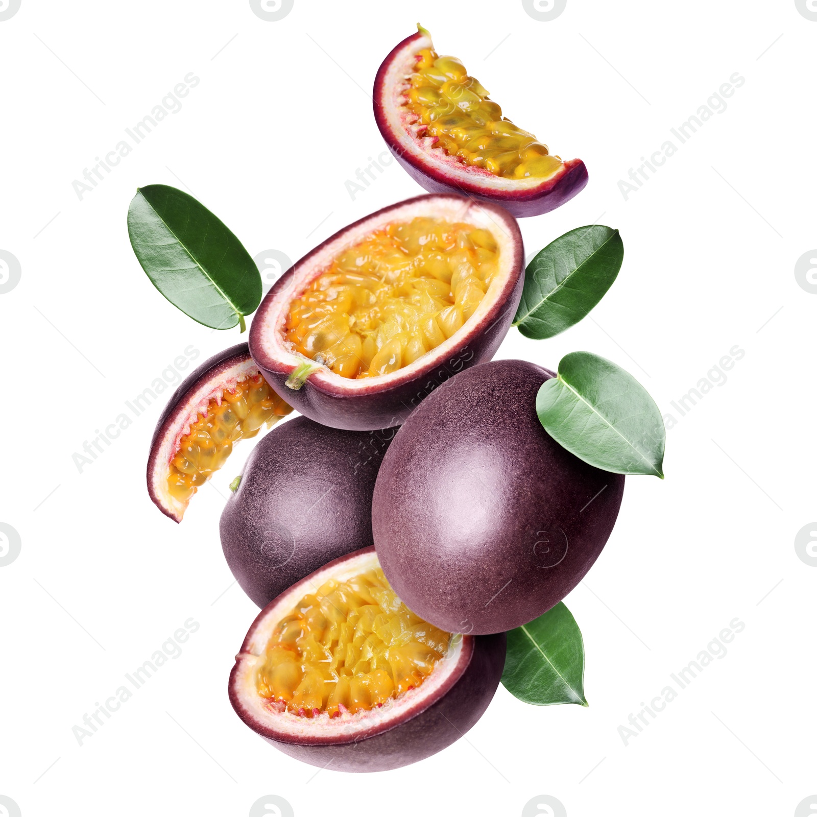 Delicious ripe passion fruits and green leaves falling on white background Image of Delicious ripe passion fruits and green leaves falling on white background