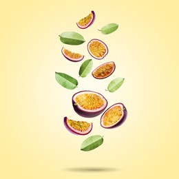 Image of Delicious cut passion fruits and green leaves falling on pale yellow gradient background