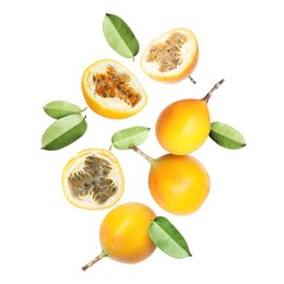 Image of Delicious ripe passion fruits and green leaves falling on white background