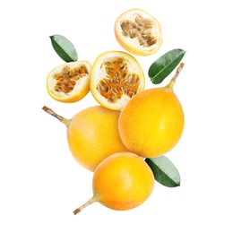 Image of Delicious ripe passion fruits and green leaves falling on white background