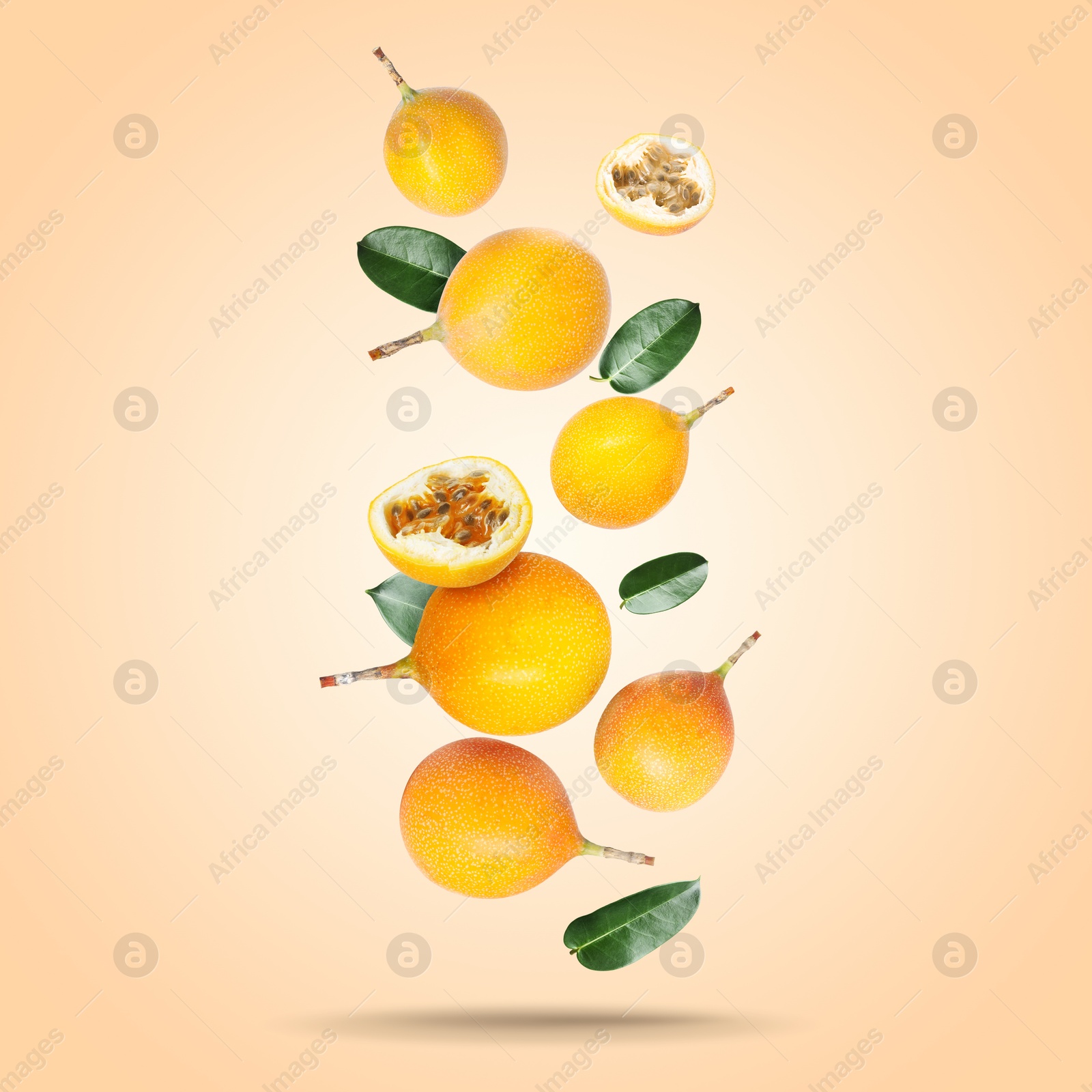Delicious ripe passion fruits with green leaves falling on pink beige gradient background Image of Delicious ripe passion fruits with green leaves falling on pink beige gradient background