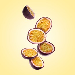 Image of Delicious cut passion fruits falling on pale yellow gradient background