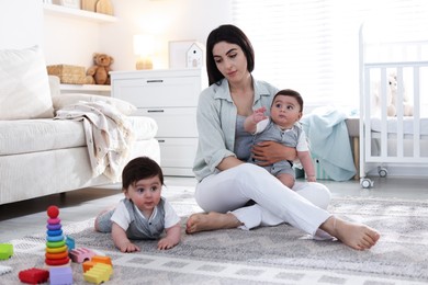 Photo of Woman suffering from postpartum depression with her little children at home