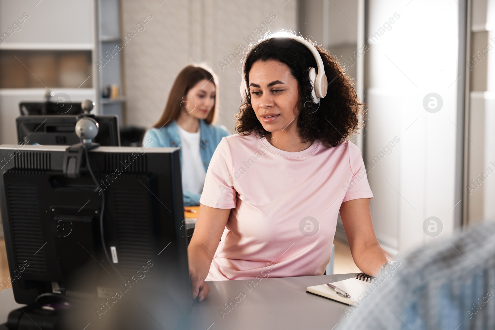 People working at desks in library, selective focus Photo of People working at desks in library, selective focus