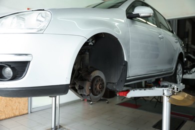 Photo of Lifted automobile during tire change at car service