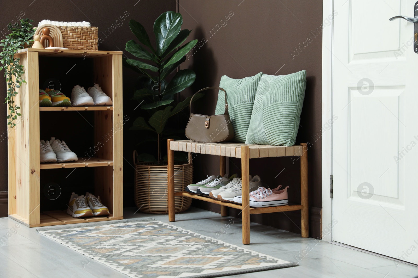 Different footwear on shelves in entryway. Shoe storage Photo of Different footwear on shelves in entryway. Shoe storage