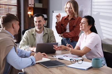 Photo of Marketing. Team of businesspeople working together at desk in office