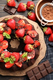 Photo of Delicious bundt cake with strawberries, mint and chocolate shavings on wooden table, flat lay