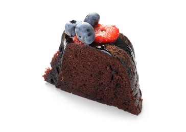 Photo of Piece of delicious chocolate bundt cake with strawberries and blueberries isolated on white