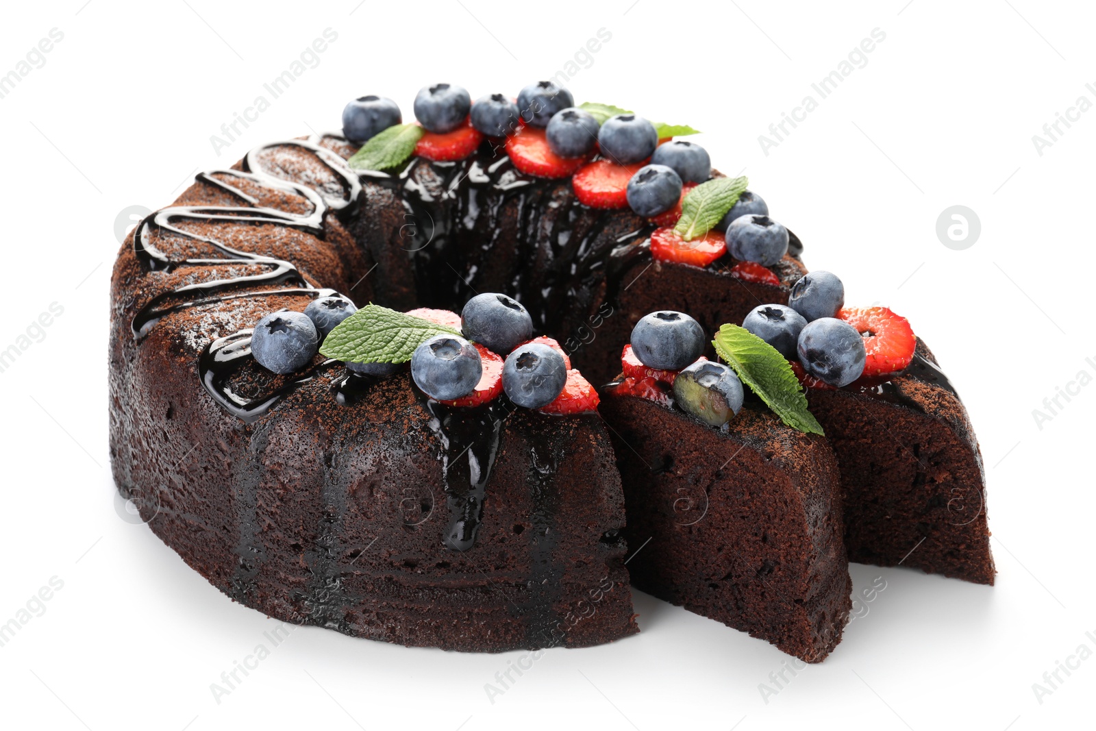 Delicious chocolate bundt cake with strawberries, mint and blueberries isolated on white Photo of Delicious chocolate bundt cake with strawberries, mint and blueberries isolated on white