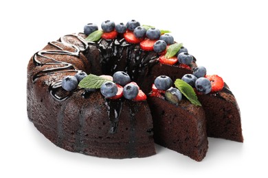Photo of Delicious chocolate bundt cake with strawberries, mint and blueberries isolated on white