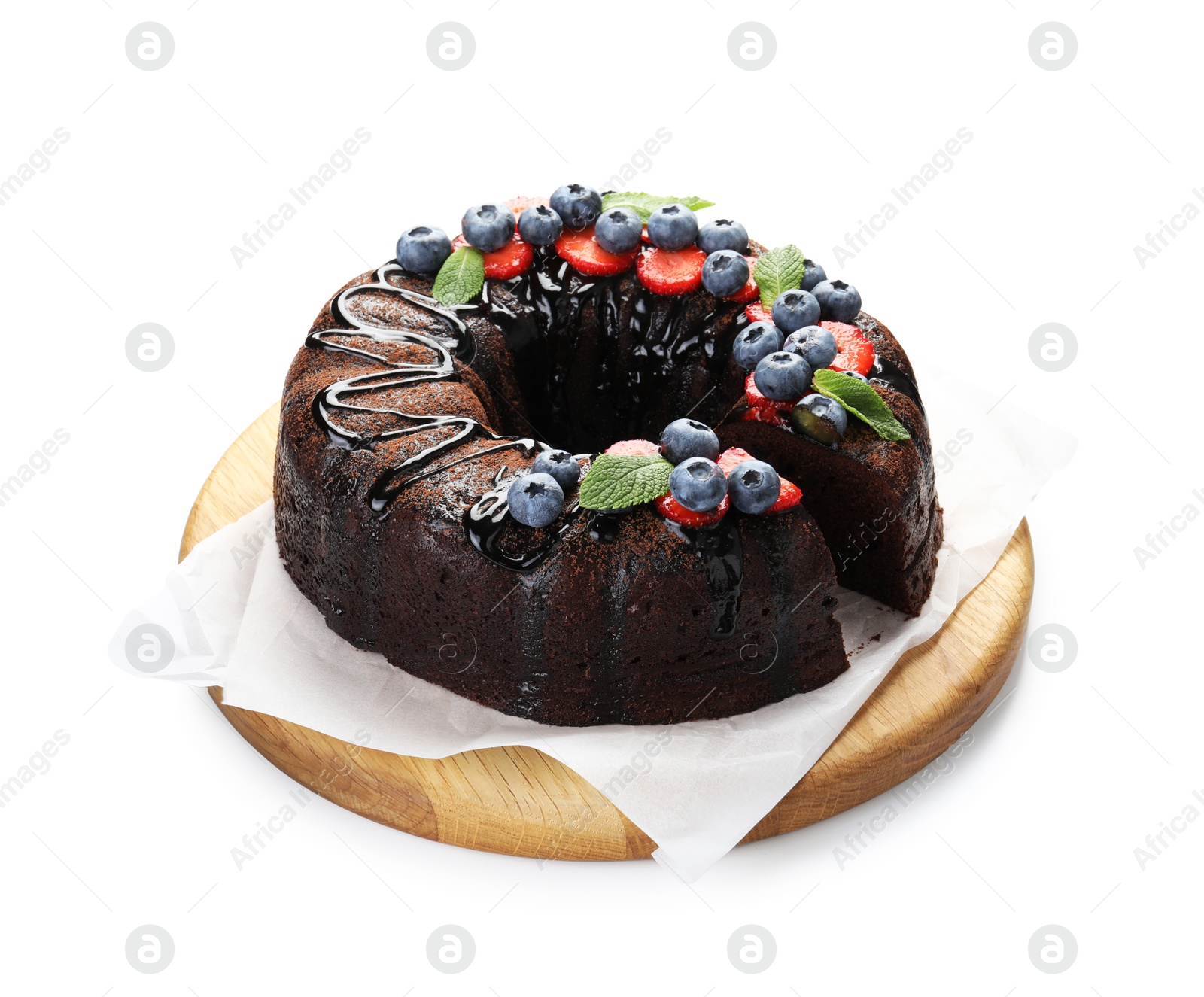 Delicious chocolate bundt cake with strawberries, mint and blueberries isolated on white Photo of Delicious chocolate bundt cake with strawberries, mint and blueberries isolated on white