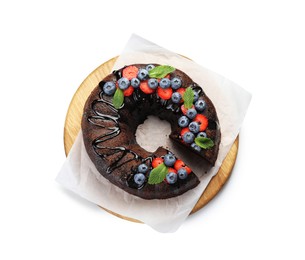 Photo of Delicious chocolate bundt cake with strawberries, mint and blueberries isolated on white, top view
