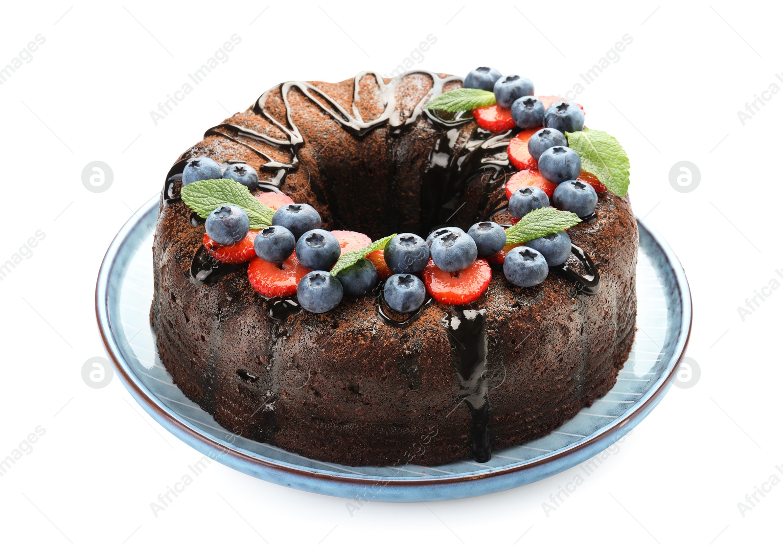 Delicious chocolate bundt cake with strawberries, mint and blueberries isolated on white Photo of Delicious chocolate bundt cake with strawberries, mint and blueberries isolated on white