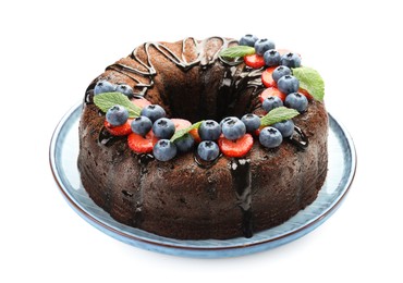 Photo of Delicious chocolate bundt cake with strawberries, mint and blueberries isolated on white