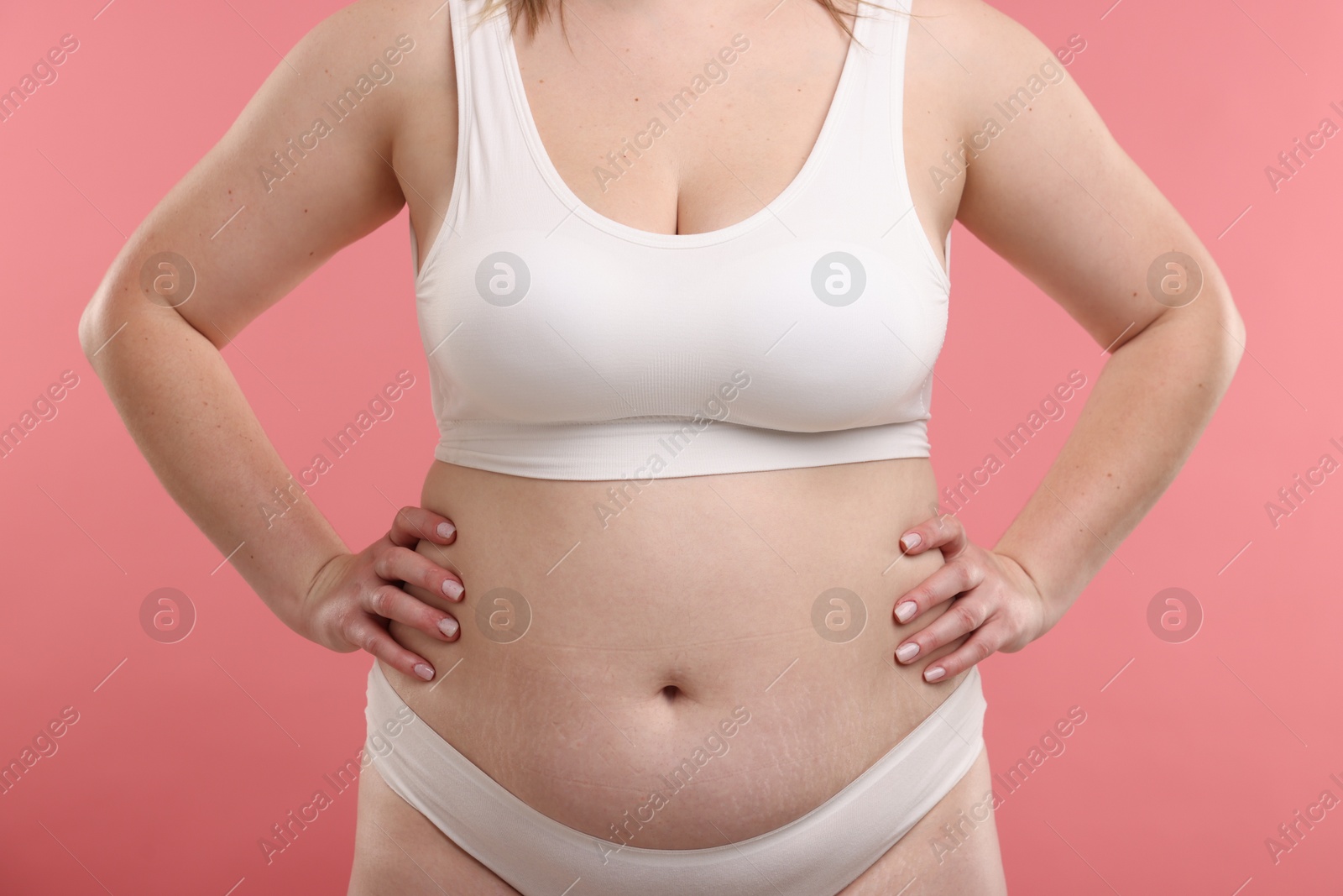 Weight loss. Plus size woman in underwear on pink background, closeup Photo of Weight loss. Plus size woman in underwear on pink background, closeup