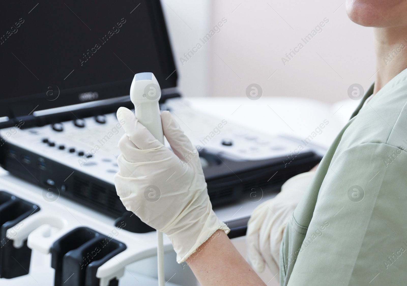 Professional sonographer with ultrasound machine in clinic Photo of Professional sonographer with ultrasound machine in clinic