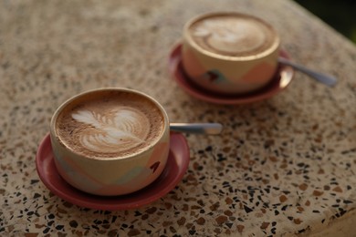 Photo of Aromatic coffee served on light table, closeup
