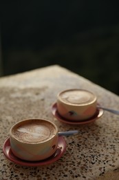 Photo of Aromatic coffee served on light table, closeup