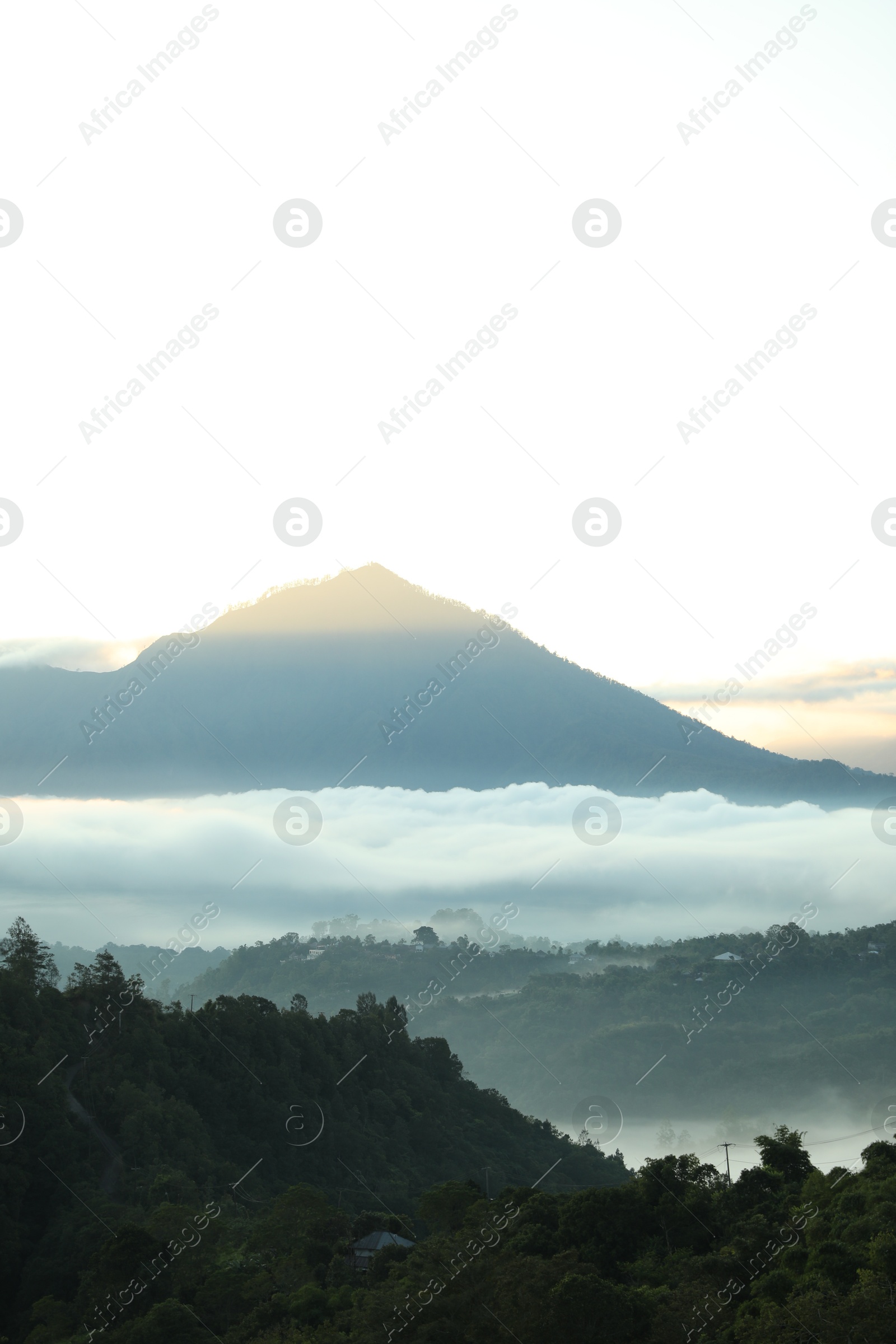 Picturesque view of mountains covered with fog on sunset Photo of Picturesque view of mountains covered with fog on sunset