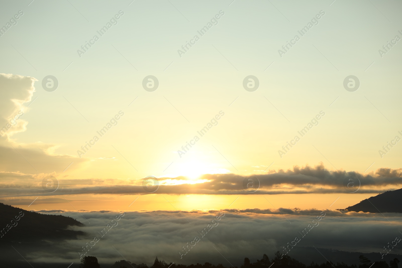 Picturesque view of mountains covered with fog on sunset Photo of Picturesque view of mountains covered with fog on sunset
