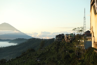 Photo of Many residential buildings and trees on mountain